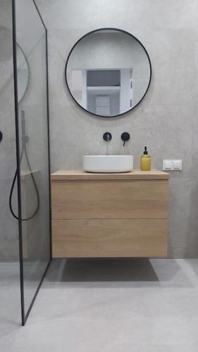 a bathroom with a sink and a mirror at Apartament PRIME Self check-in in Rzeszów