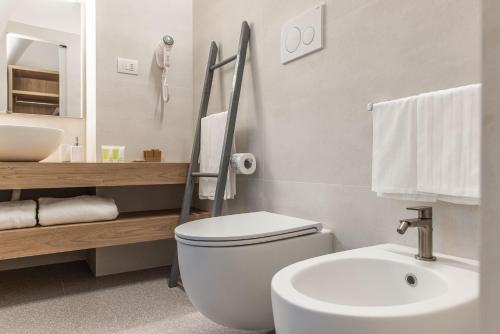 a bathroom with a white toilet and a sink at Dimora dei Celestini in Manfredonia