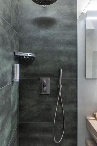 a bathroom with a shower with a glass door at Dimora dei Celestini in Manfredonia