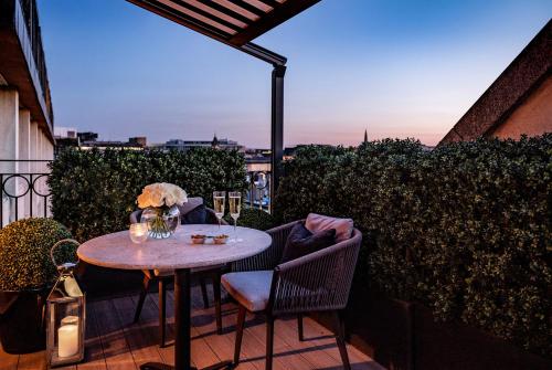 a table and chairs on a balcony with a view at The Westbury Hotel in Dublin