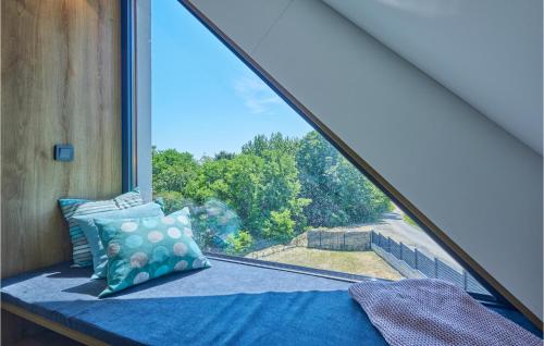 a bed in a room with a large window at Lovely Home In Bedenica With Jacuzzi in Bedenica