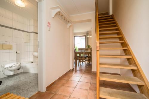 a staircase in a room with a toilet and a bathroom at Fischerhaus 309 in Rechlin