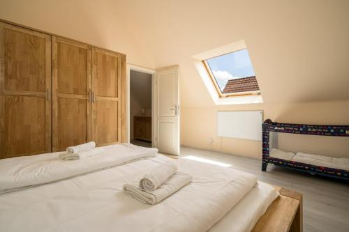 a bedroom with a large bed with two towels on it at Fischerhaus 309 in Rechlin