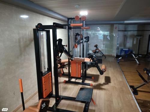 a gym with a person in a gym with machines at Beach Suite Israel- True Beachfront Steps Away From Beach ביץ סוייט ישראל- במרחק צעדים מהים in Ashqelon