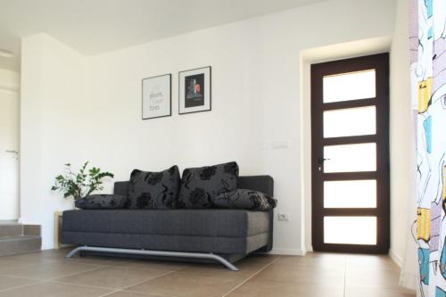 a living room with a couch and a door at Apartment Vita in Funtana