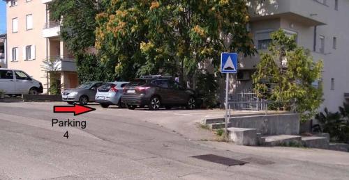 a street with cars parked in a parking lot at Apartman 4 in Rijeka
