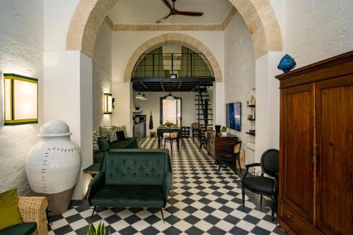 a lobby with chairs and tables and a ceiling fan at Loft 900 - Home & SPA - A Timeless Luxury in Monopoli in Monopoli