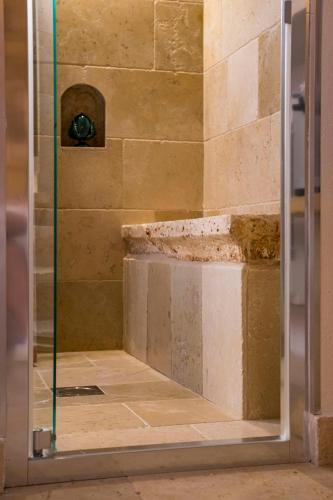a shower with a glass door in a bathroom at Loft 900 - Home & SPA - A Timeless Luxury in Monopoli in Monopoli