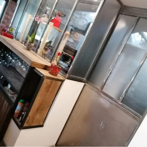 a kitchen with a stainless steel refrigerator at Mas L'Escale des Dentelles in Aubignan