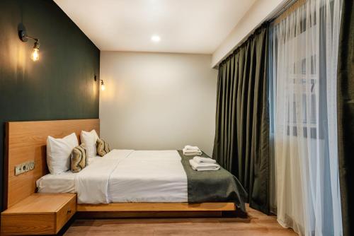 a hotel room with a bed and a window at Bakuriani Inn in Bakuriani