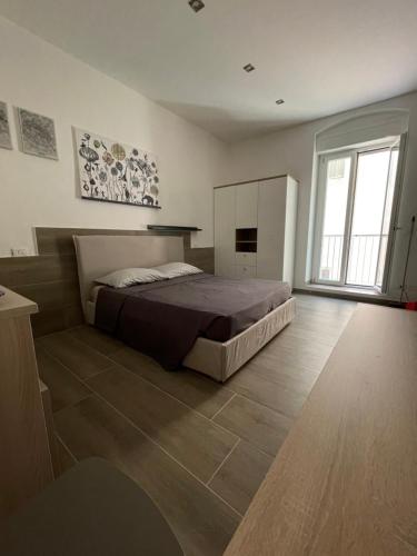 a large bedroom with a bed and a large window at Casa vacanze San Francesco in Barletta