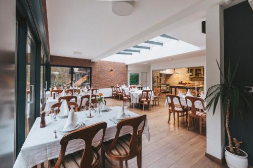a dining room with a long table and chairs at Guesthouse Villa Zelenjak Ventek in Kumrovec