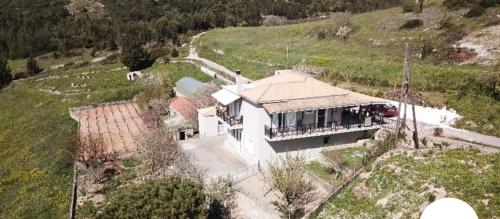 an aerial view of a house on a hill at Farmhouse in Volimes