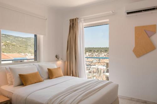 a bedroom with a large bed and a large window at The Blue in Skiathos