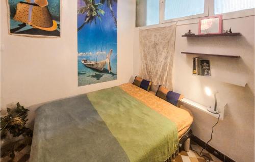 a bedroom with a bed and a painting on the wall at Nice Apartment In Saint-tienne With Kitchen in Saint-Étienne