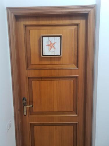 a wooden door with a star above it at NEL BLU in Porto SantʼElpidio