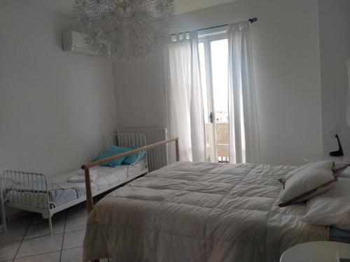 a bedroom with a large bed and a window at NEL BLU in Porto SantʼElpidio