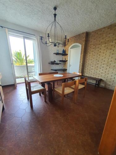 a dining room with a table and chairs and a chandelier at NEL BLU in Porto SantʼElpidio