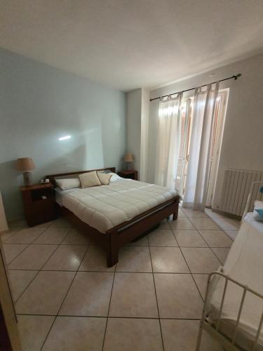 a bedroom with a bed and a tiled floor at NEL BLU in Porto SantʼElpidio