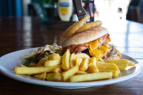 a plate of food with a sandwich and french fries at Loch Lomond Hotel in Balloch