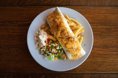 a plate of food with a fish sandwich and french fries at Loch Lomond Hotel in Balloch