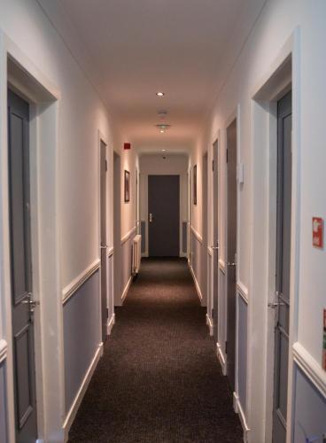 a hallway of an office building with a long corridor at Loch Lomond Hotel in Balloch