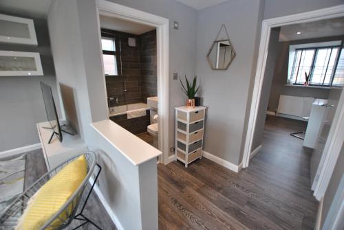 a bathroom with a sink and a toilet and a mirror at Executive Apartment in Central Windsor in Windsor