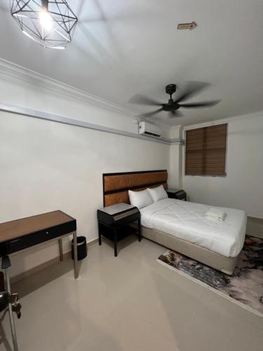 a bedroom with a bed and a ceiling fan at Laena Homestay in Kangar