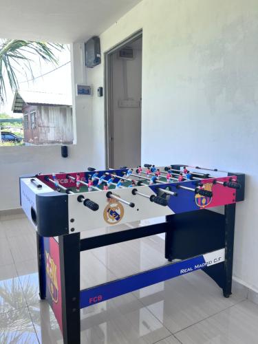a foosball table in the middle of a room at Sungai endau bilik homestay in Kuala Rompin