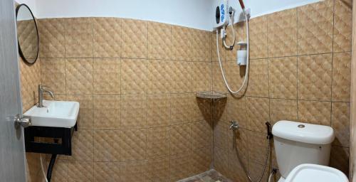 a bathroom with a shower and a toilet and a sink at Sungai endau bilik homestay in Kuala Rompin