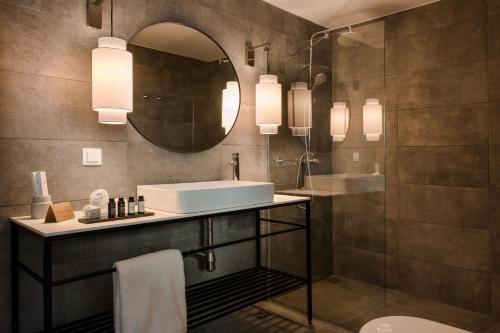 a bathroom with a sink and a mirror at The Rock in Skiathos Town