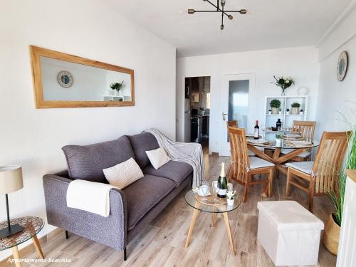 a living room with a couch and a table at Sublime sea view apartement in Calafell