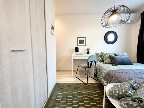 een kleine slaapkamer met een bed en een bureau bij TYO Ikebukuro Designer’s Apt 102 in Tokyo