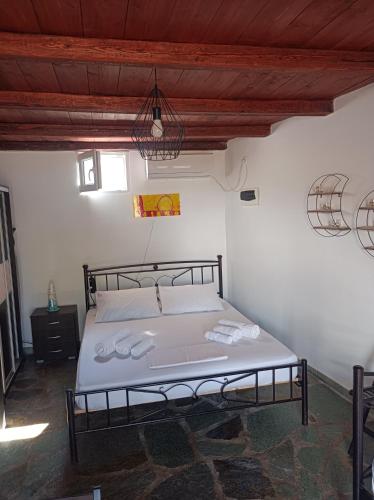 a bedroom with a large bed in a room at Aelia Kithnos in Kithnos
