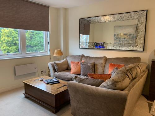 a living room with a couch and a coffee table at 4 The Courtyard Central Windsor 2BR in Windsor