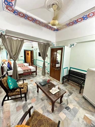 a living room with a bed and a couch at Rawla Mrignayani Palace in Jaipur