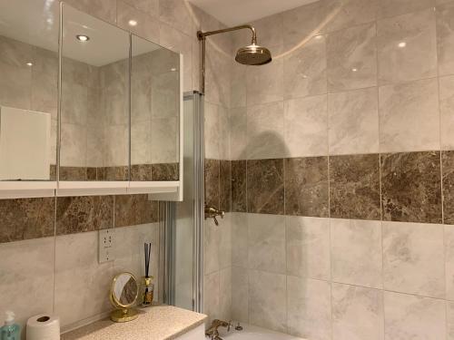 a bathroom with a shower with a glass door at 2 Bedroom Apartment in Central Windsor in Windsor