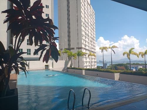 a large swimming pool in the middle of a building at Deluxe suites 3, 1BR, 2-5 pax, Netflix, Georgetown in George Town