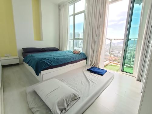 a bedroom with a bed and a large window at Deluxe suites 3, 1BR, 2-5 pax, Netflix, Georgetown in George Town