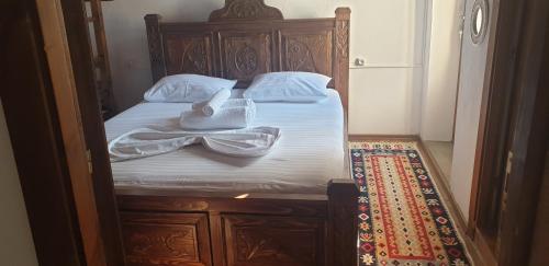a bedroom with a bed with two towels on it at Silver Hill Guesthouse in Gjirokastër