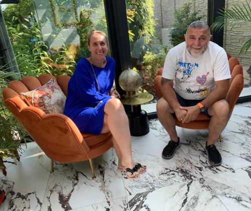 an older man and woman sitting in chairs at Les Suites Champenoises in Reims