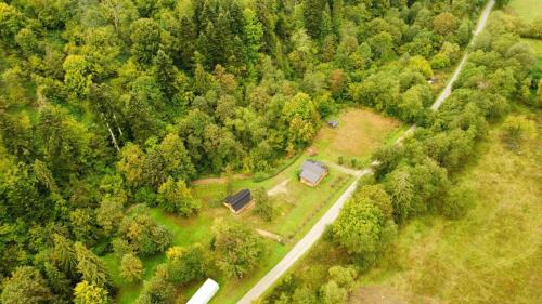 an aerial view of a house in the middle of a forest at Nad Głuchym Potokiem in Rosochate