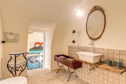 a bathroom with a sink and a mirror on the wall at Vico Street 2 in Naples