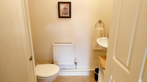 a bathroom with a toilet and a sink at Avalon Retreat Self Catering Vegetarian Accommodation in the Heart of Glastonbury in Glastonbury