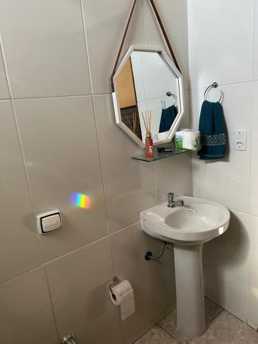 a bathroom with a sink and a mirror at Casa do Marquinho in Aparecida