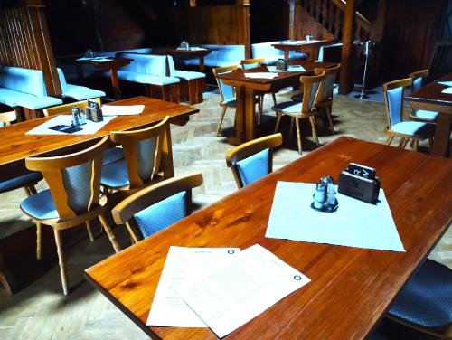 an empty restaurant with wooden tables and chairs at Obří Sud Libverda *** in Lázně Libverda