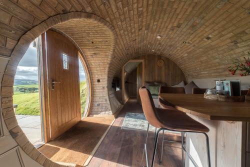 a circular room with a table and chairs at Hares View in Rhayader
