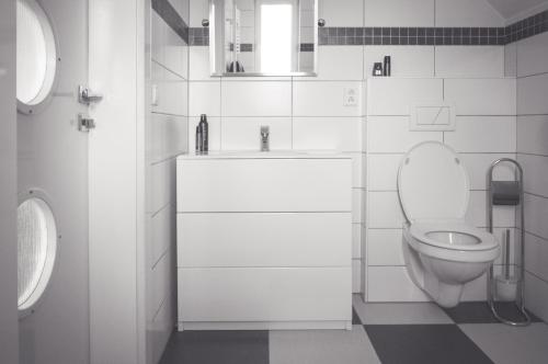 a white bathroom with a toilet and a sink at Ubytování Kateřina in Skalná