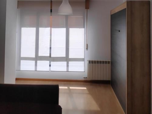 a living room with a large window and a couch at Estudio Francés, Parking privado gratuito in Logroño