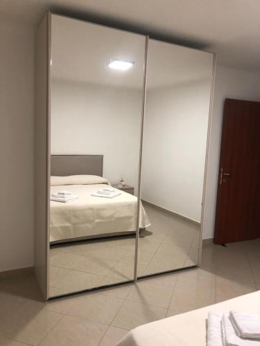 a large mirror in a bedroom with a bed at Rosabella Casa Vacanze in Bari